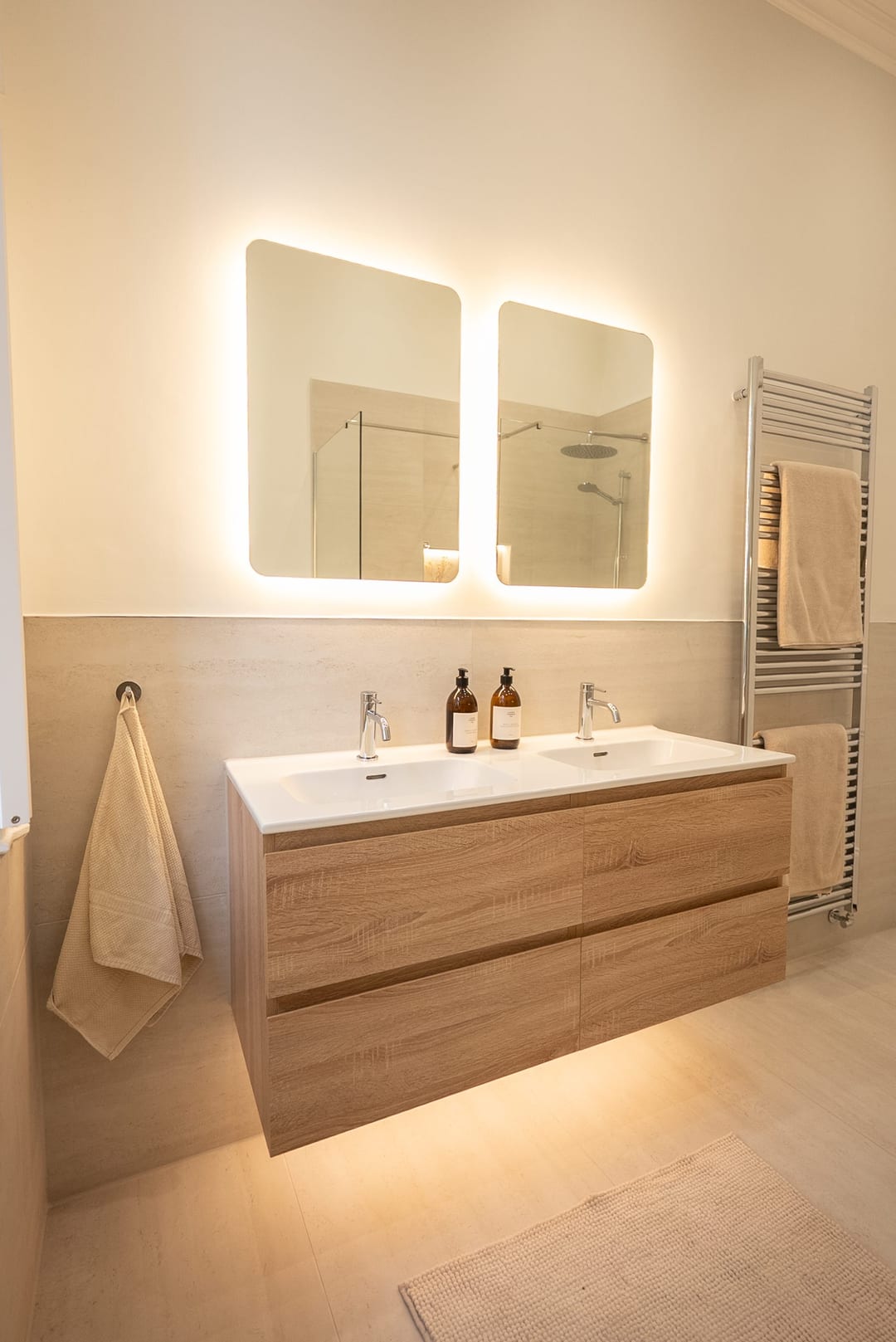 En-suite bathroom with a timber vanity, bath and large window