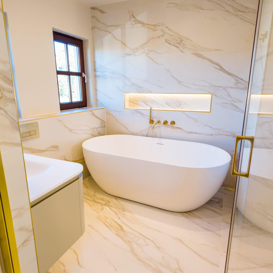 Luxury Edinburgh bathroom with Calacatta marble walls, freestanding bath and brass fittings